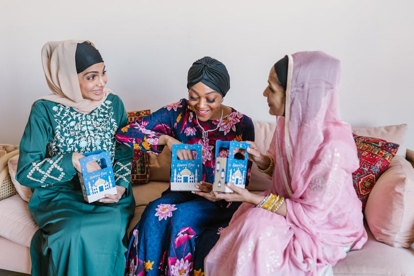 3 women sitting on sofa enjoying eid ul fitr holidays in uae