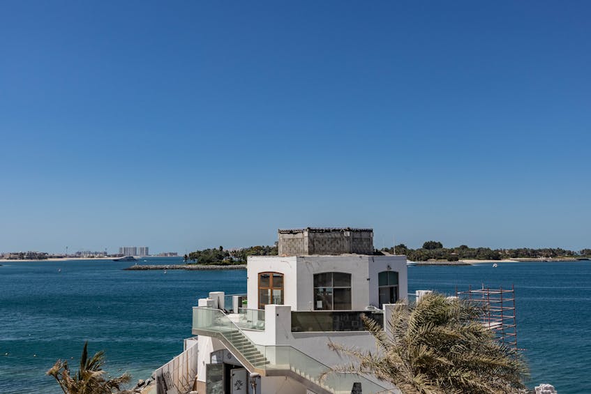 Seaside villa in Ajman showcasing essential home maintenance near waterfront