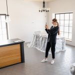 Real estate agent capturing photos of a modern unfurnished apartment to get property valuation